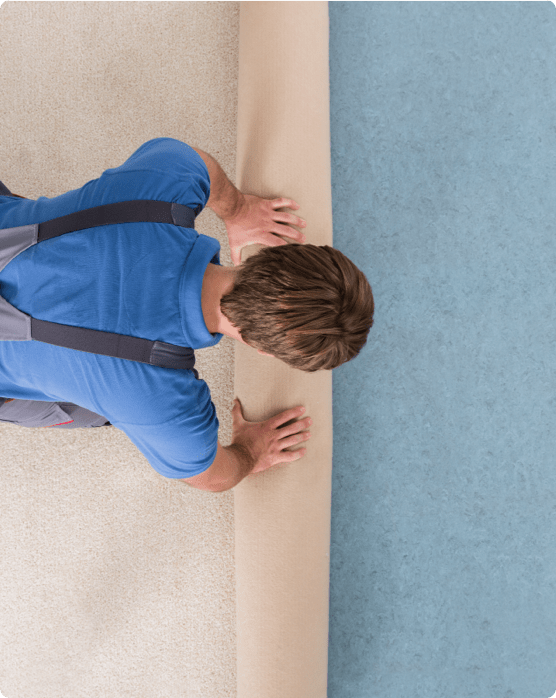 Man rolling carpet for installation | Kelly's Carpet Omaha